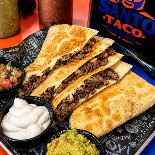 Four Santo Taco quesadillas with ground beef, served with pico de gallo, sour cream, and guacamole.