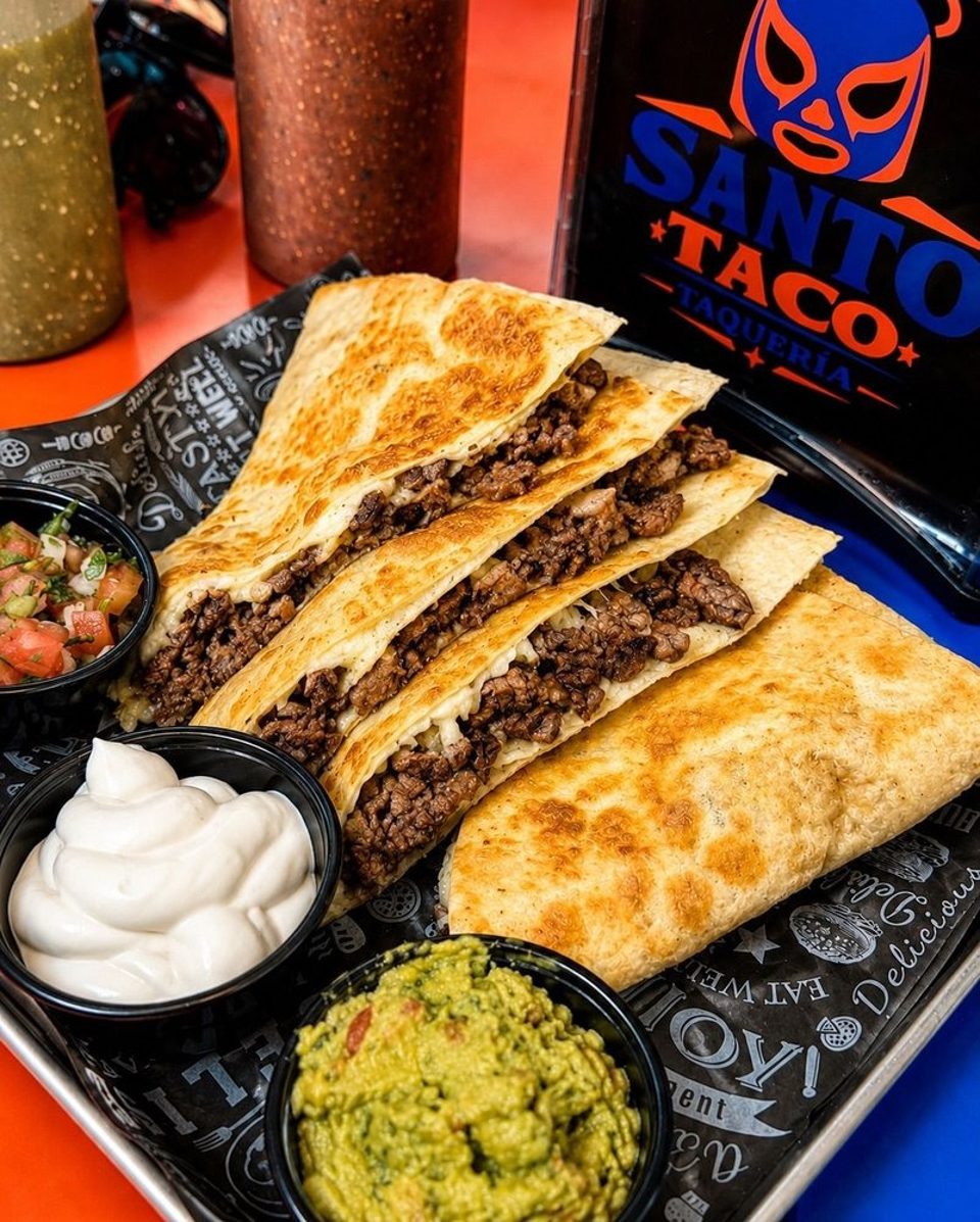 Four Santo Taco quesadillas with ground beef, served with pico de gallo, sour cream, and guacamole.
